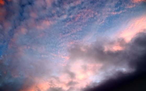 Beautiful panorama of orange and yellow clouds at sunrise and sunset in a blue sky