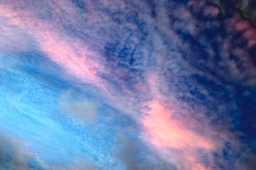 Beautiful panorama of orange and yellow clouds at sunrise and sunset in a blue sky