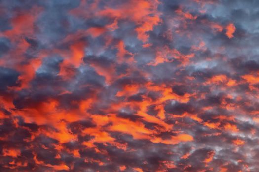 Beautiful panorama of orange and yellow clouds at sunrise and sunset in a blue sky