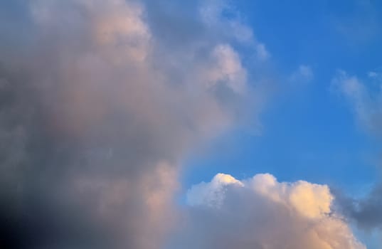 Beautiful panorama of orange and yellow clouds at sunrise and sunset in a blue sky