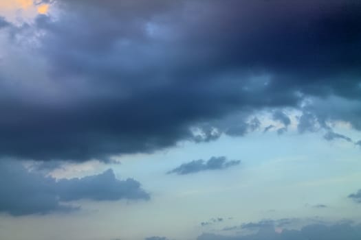 Beautiful panorama of orange and yellow clouds at sunrise and sunset in a blue sky