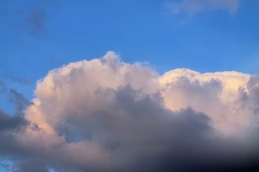 Beautiful panorama of orange and yellow clouds at sunrise and sunset in a blue sky