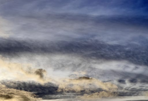 Beautiful panorama of orange and yellow clouds at sunrise and sunset in a blue sky