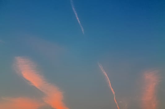 Beautiful panorama of orange and yellow clouds at sunrise and sunset in a blue sky