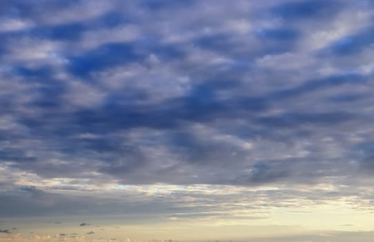 Beautiful panorama of orange and yellow clouds at sunrise and sunset in a blue sky