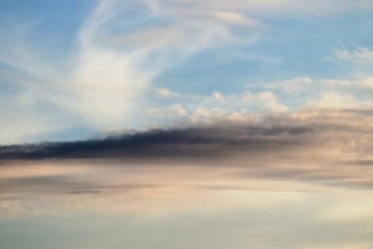 Beautiful panorama of orange and yellow clouds at sunrise and sunset in a blue sky