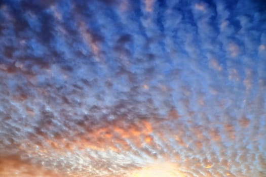 Beautiful panorama of orange and yellow clouds at sunrise and sunset in a blue sky