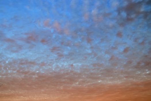 Beautiful panorama of orange and yellow clouds at sunrise and sunset in a blue sky