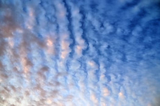 Beautiful panorama of orange and yellow clouds at sunrise and sunset in a blue sky