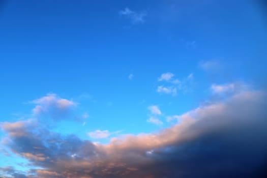 Beautiful panorama of orange and yellow clouds at sunrise and sunset in a blue sky