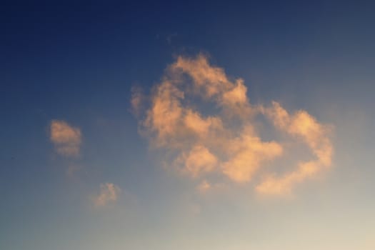 Beautiful panorama of orange and yellow clouds at sunrise and sunset in a blue sky