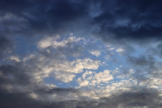 Beautiful panorama of orange and yellow clouds at sunrise and sunset in a blue sky