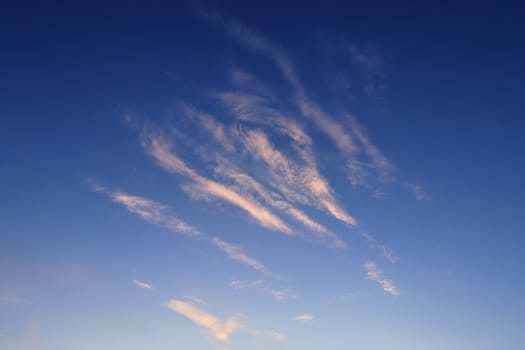 Beautiful panorama of orange and yellow clouds at sunrise and sunset in a blue sky