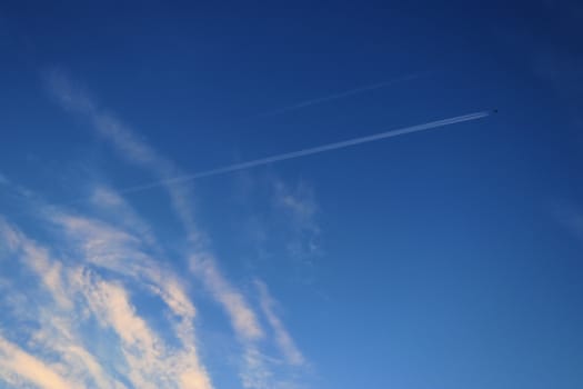 Beautiful panorama of orange and yellow clouds at sunrise and sunset in a blue sky