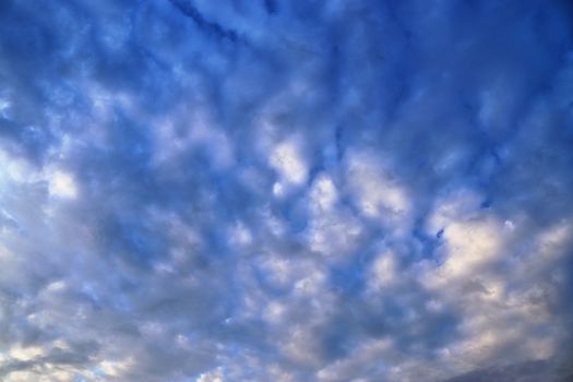 Beautiful panorama of orange and yellow clouds at sunrise and sunset in a blue sky