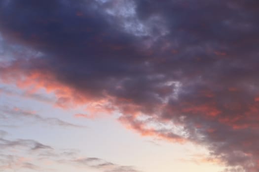 Beautiful panorama of orange and yellow clouds at sunrise and sunset in a blue sky