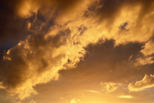 Beautiful panorama of orange and yellow clouds at sunrise and sunset in a blue sky