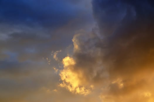 Beautiful panorama of orange and yellow clouds at sunrise and sunset in a blue sky