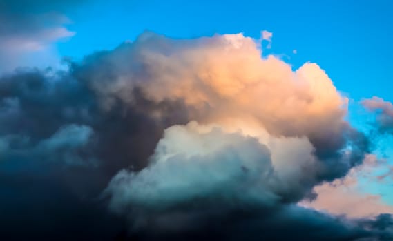 Beautiful panorama of orange and yellow clouds at sunrise and sunset in a blue sky