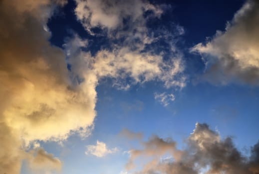 Beautiful panorama of orange and yellow clouds at sunrise and sunset in a blue sky