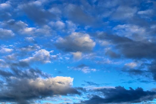 Beautiful panorama of orange and yellow clouds at sunrise and sunset in a blue sky