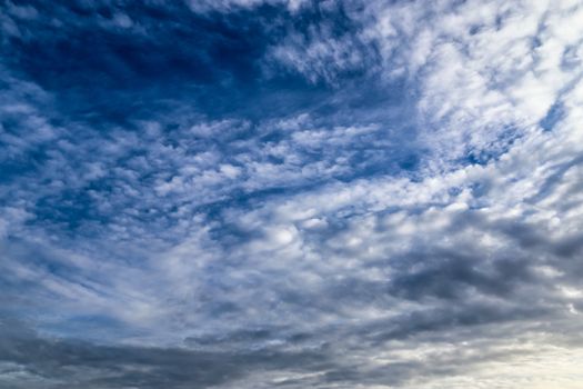 Beautiful panorama of orange and yellow clouds at sunrise and sunset in a blue sky