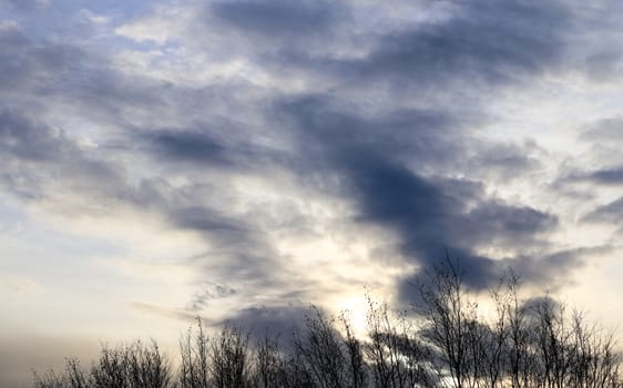 Beautiful panorama of orange and yellow clouds at sunrise and sunset in a blue sky