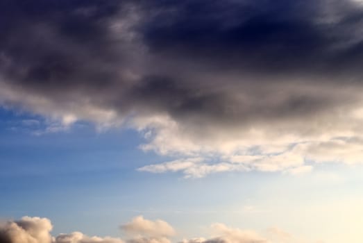 Beautiful panorama of orange and yellow clouds at sunrise and sunset in a blue sky