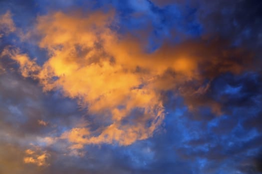 Beautiful panorama of orange and yellow clouds at sunrise and sunset in a blue sky