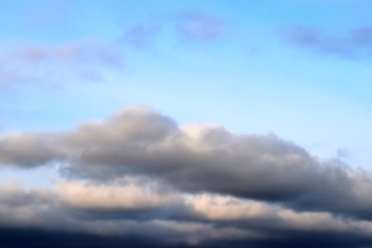 Beautiful panorama of orange and yellow clouds at sunrise and sunset in a blue sky