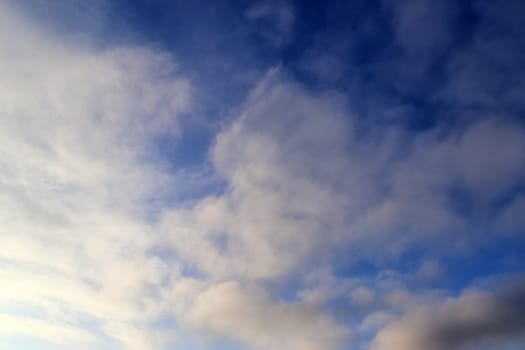 Beautiful panorama of orange and yellow clouds at sunrise and sunset in a blue sky