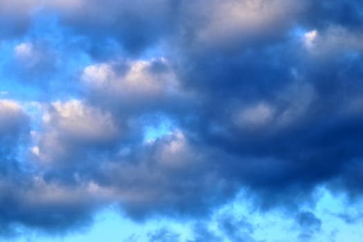 Beautiful panorama of orange and yellow clouds at sunrise and sunset in a blue sky