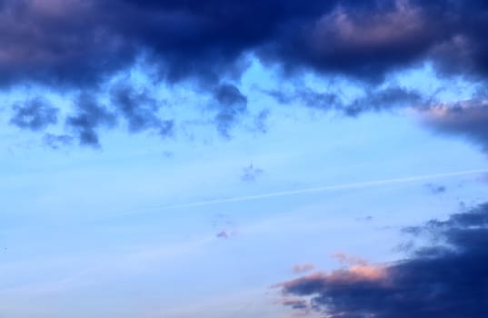 Beautiful panorama of orange and yellow clouds at sunrise and sunset in a blue sky