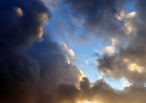 Beautiful panorama of orange and yellow clouds at sunrise and sunset in a blue sky