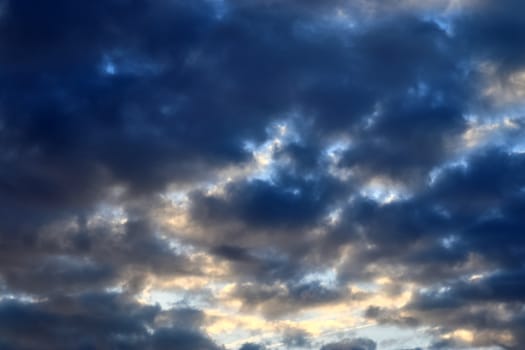 Beautiful panorama of orange and yellow clouds at sunrise and sunset in a blue sky