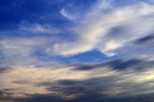 Beautiful panorama of orange and yellow clouds at sunrise and sunset in a blue sky