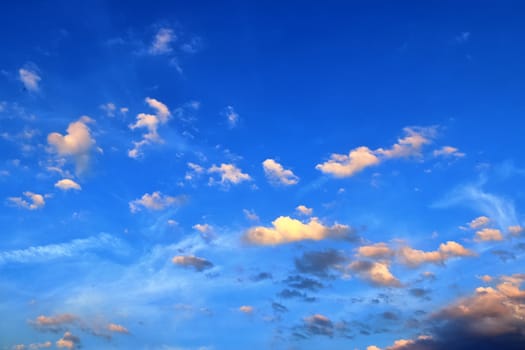 Beautiful panorama of orange and yellow clouds at sunrise and sunset in a blue sky