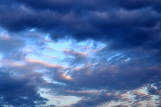 Beautiful panorama of orange and yellow clouds at sunrise and sunset in a blue sky