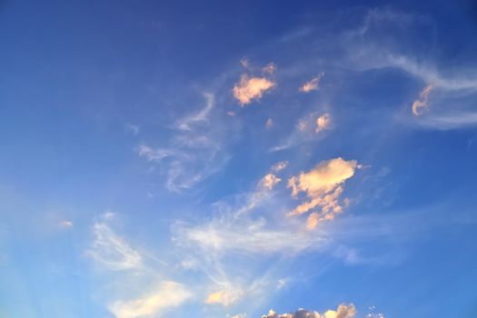 Beautiful panorama of orange and yellow clouds at sunrise and sunset in a blue sky