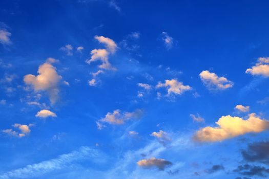 Beautiful panorama of orange and yellow clouds at sunrise and sunset in a blue sky