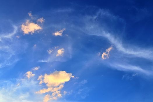 Beautiful panorama of orange and yellow clouds at sunrise and sunset in a blue sky