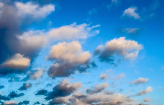 Beautiful panorama of orange and yellow clouds at sunrise and sunset in a blue sky