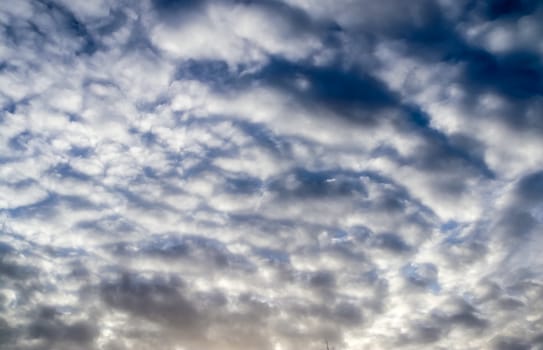 Beautiful panorama of orange and yellow clouds at sunrise and sunset in a blue sky