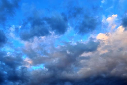 Beautiful panorama of orange and yellow clouds at sunrise and sunset in a blue sky