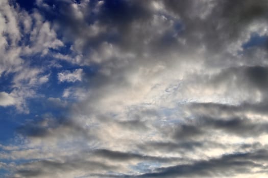 Beautiful panorama of orange and yellow clouds at sunrise and sunset in a blue sky