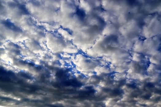 Beautiful panorama of orange and yellow clouds at sunrise and sunset in a blue sky