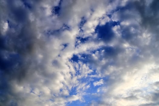 Beautiful panorama of orange and yellow clouds at sunrise and sunset in a blue sky