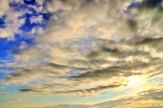 Beautiful panorama of orange and yellow clouds at sunrise and sunset in a blue sky