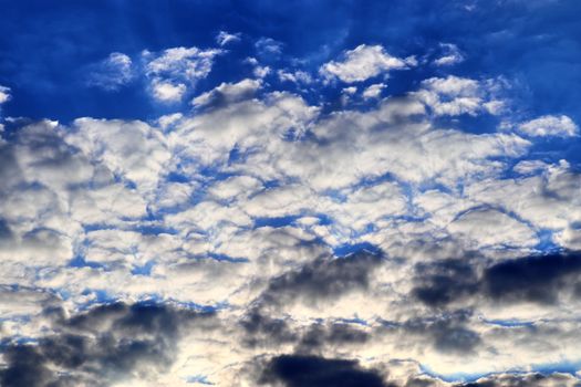 Beautiful panorama of orange and yellow clouds at sunrise and sunset in a blue sky