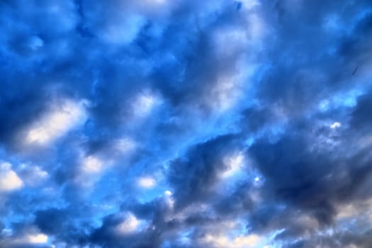 Beautiful panorama of orange and yellow clouds at sunrise and sunset in a blue sky